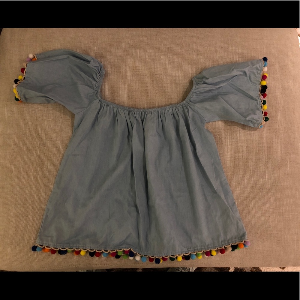 Blue jean and Pom Pom off the shoulder shirt